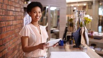 black business owner facing camera smiling